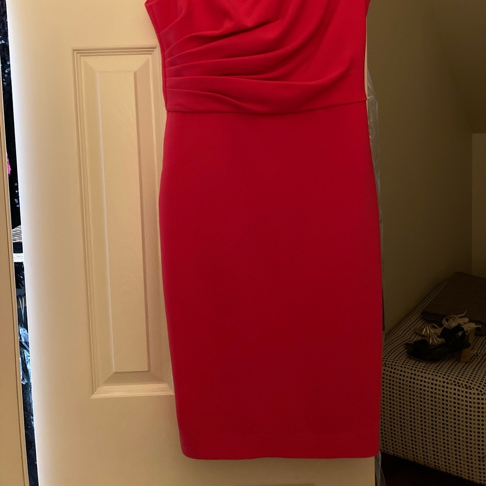 Asymmetrical neck with gathered bodice and cap sleeves.